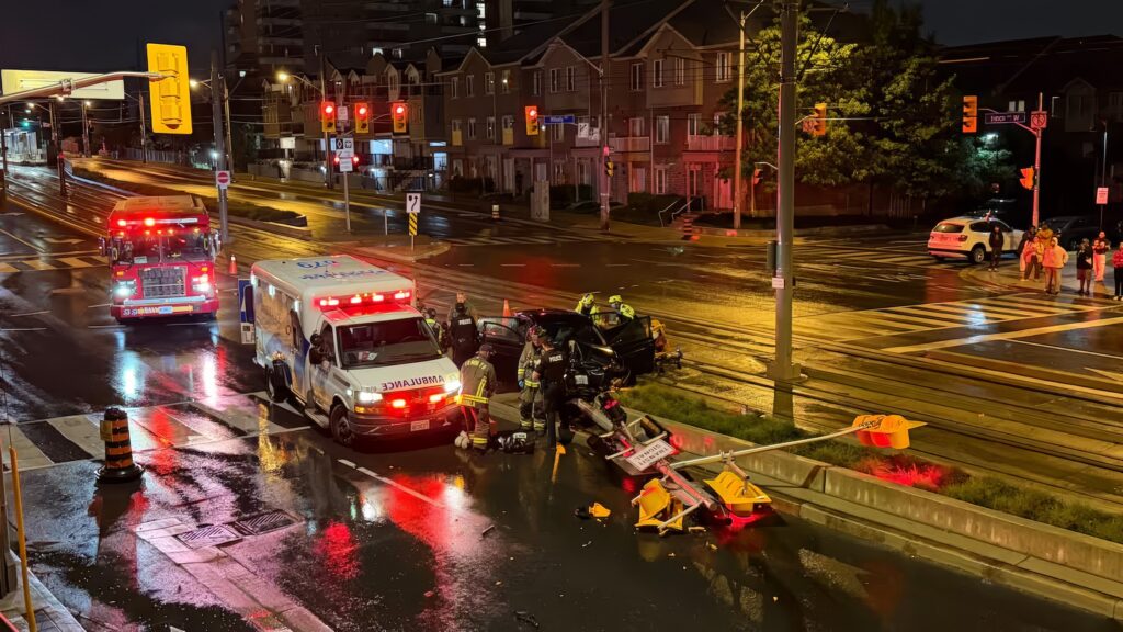 Crash scene at Islington and Finch in Toronto, 2026-06-18, showing a crashed car blocking LRT tracks