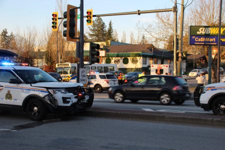 A damaged police cruiser at the intersection of 104 Ave & King George Blvd following a collision. A passing 320 bus is shown in the background. Taken 4/25/2018 by <a href="https://vancouverfirepics.smugmug.com/RCMP-mvi/n-nHSP5q/i-dZrW3fN">Shane MacKichan</a>