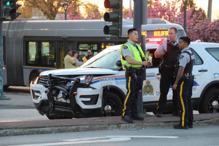 A damaged police cruiser at the intersection of 104 Ave & King George Blvd following a collision. A passing 96 B-Line bus is shown in the background. Taken 4/25/2018 by <a href="https://vancouverfirepics.smugmug.com/RCMP-mvi/n-nHSP5q/i-dZrW3fN">Shane MacKichan</a>